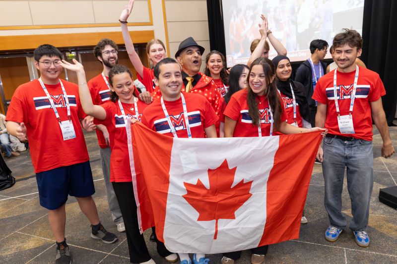 Team celebrating with the Canadian flag